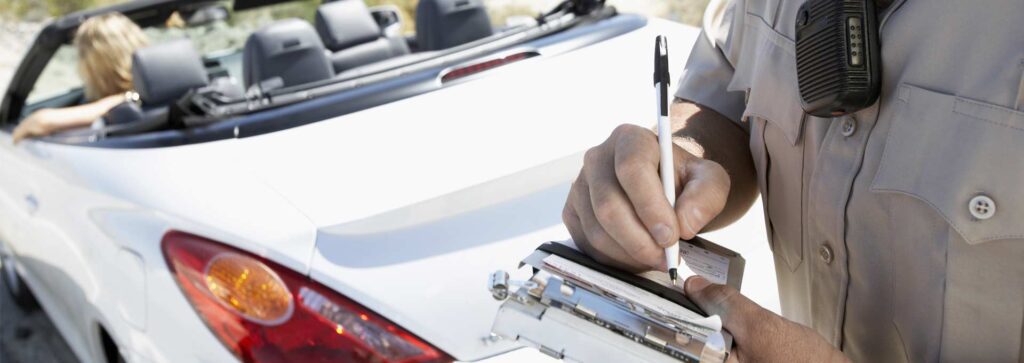An officer writing out a traffic violation.